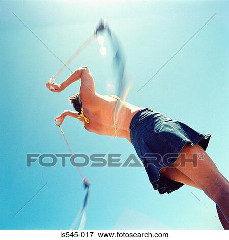 Stock Photo - bikini, blue sky, holiday, miniskirt, summer. Fotosearch