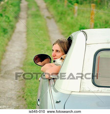 Stock Image - car, country road, countryside, dog, holiday. Fotosearch