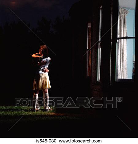 Stock Image - couple, dark, evening, house, hugging. Fotosearch