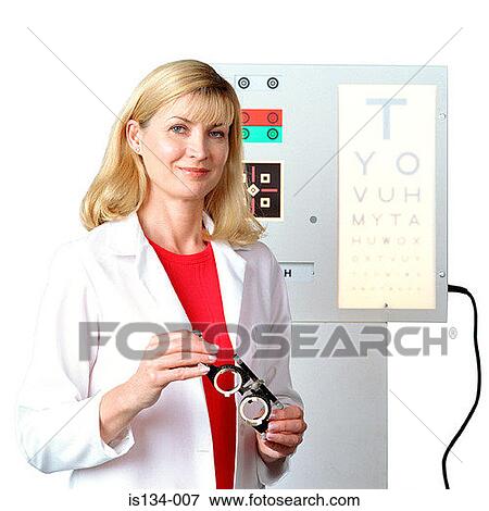 Stock Photo - Caucasian, eye chart, eyeglasses, female, holding. Fotosearch