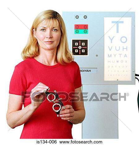 Stock Photograph - Caucasian, eye chart, eyeglasses, female, holding. Fotosearch