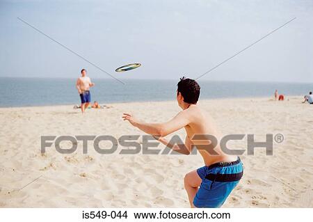 Boys playing quoits on the beach View Large Photo Image Picture - Boys playing quoits on the beach. Fotosearch
