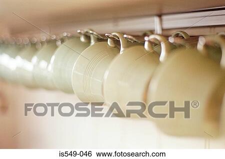 Cups hanging on a rack View Large Photo Image Stock Photograph - Cups hanging on a rack. Fotosearch