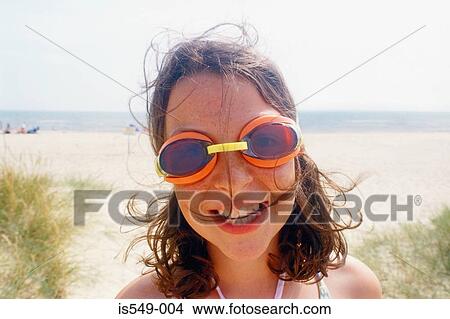 Girl on the beach with swimming goggles View Large Photo Image Picture - Girl on the beach with swimming goggles. Fotosearch