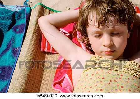 Stock Image - Girl sunbathing. Fotosearch