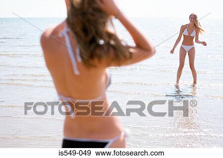 Stock Photo - Girls on the beach. Fotosearch
