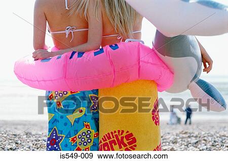 Girls on the beach with inflatable lifebelt View Large Photo Image Stock Photo - Girls on the beach with inflatable lifebelt. Fotosearch