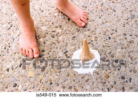 Stock Photography - Melting ice cream by child's feet. Fotosearch