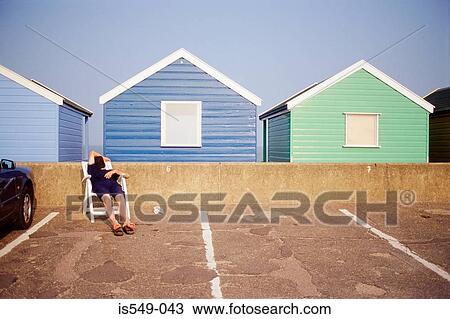 Sunbathing in a car park View Large Photo Image Stock Image - Sunbathing in a car park. Fotosearch