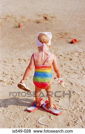 Toddler on the beach View Large Photo Image Stock Photo - Toddler on the beach. Fotosearch