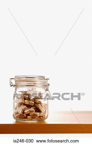 Stock Image - Star shaped iced biscuits in jar. Fotosearch