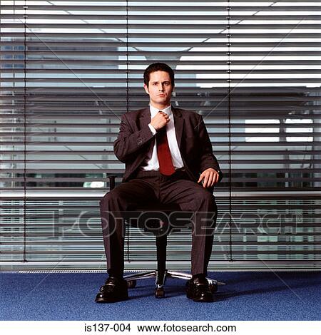 Businessman adjusting his tie View Large Photo Image Picture - Businessman adjusting his tie. Fotosearch