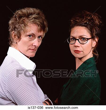 Two serious women View Large Photo Image Stock Photograph - Two serious women. Fotosearch
