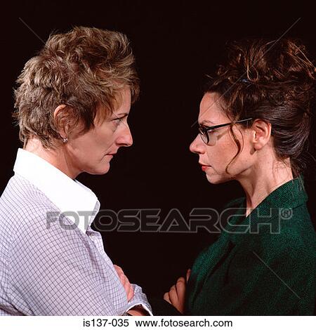 Two women staring at each other View Large Photo Image Stock Photography - Two women staring at each other. Fotosearch