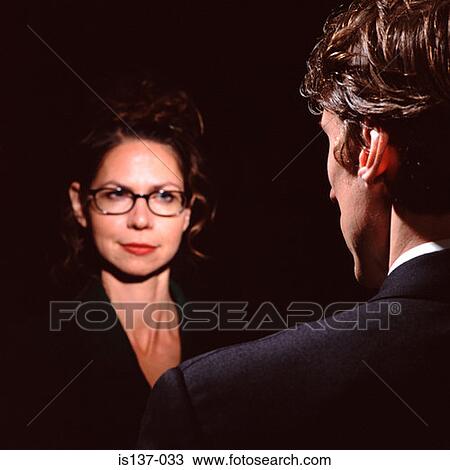 Stock Image - Woman looking at a man. Fotosearch