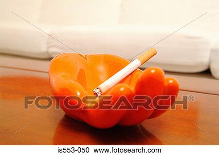 Stock Image - Cigarette in ashtray. Fotosearch