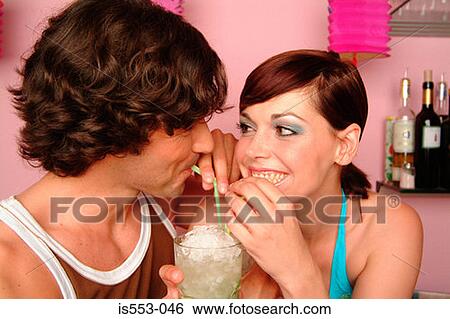 Couple enjoying cocktail View Large Photo Image Stock Photograph - Couple enjoying cocktail. Fotosearch
