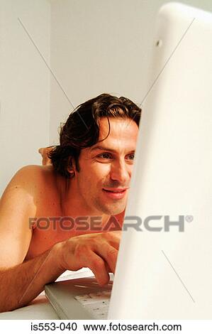 Man at home with laptop View Large Photo Image Stock Image - Man at home with laptop. Fotosearch