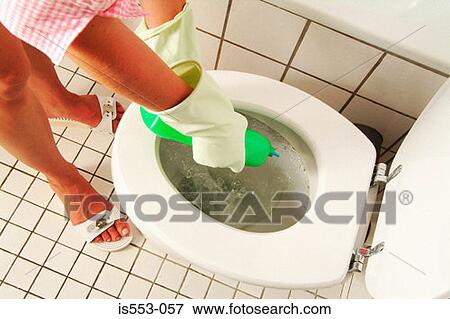 Stock Photo - Woman cleaning toilet bowl. Fotosearch