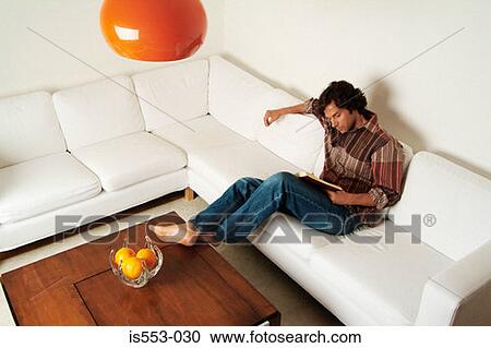 Stock Image - Young man reading book. Fotosearch