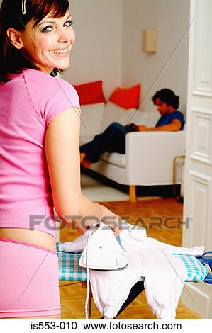 Young mother happily ironing View Large Photo Image Stock Image - Young mother happily ironing. Fotosearch