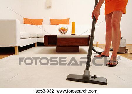 Young woman hoovering View Large Photo Image Stock Image - Young woman hoovering. Fotosearch