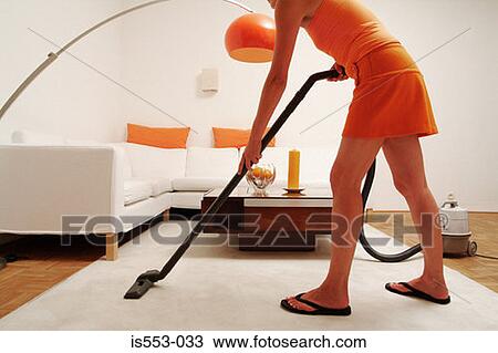 Young woman hoovering View Large Photo Image Stock Image - Young woman hoovering. Fotosearch