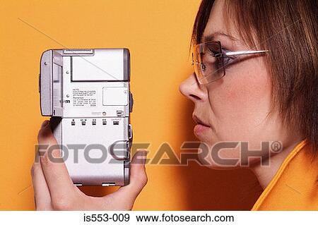 Young woman with camera View Large Photo Image Stock Photo - Young woman with camera. Fotosearch