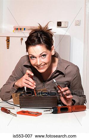 Stock Photo - Young woman with fuse-box. Fotosearch