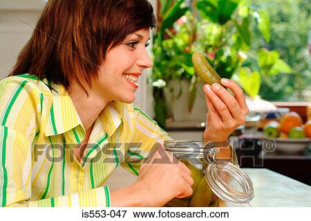 Young woman with gherkin View Large Photo Image Stock Photo - Young woman with gherkin. Fotosearch