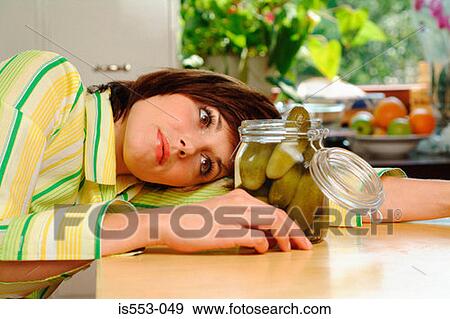 Stock Photo - Young woman with gherkins. Fotosearch
