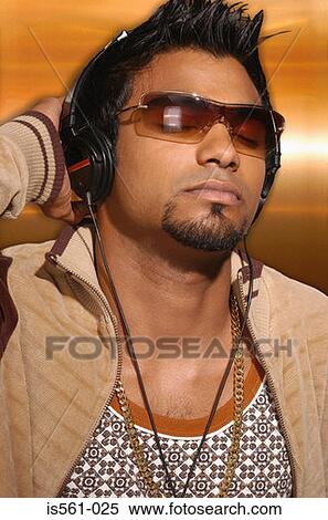 Stock Photography - Asian man wearing headphones. Fotosearch