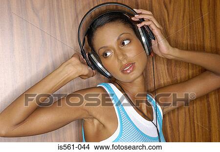 Picture - Asian woman wearing headphones. Fotosearch