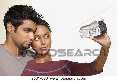Stock Image - Couple using video camera. Fotosearch