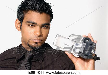 Man using video camera View Large Photo Image Stock Image - Man using video camera. Fotosearch