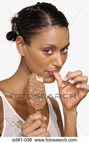 Stock Photograph - Woman eating an ice cream. Fotosearch