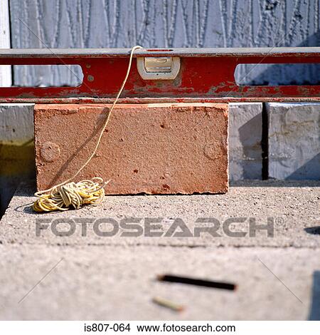 Spirit level on a brick View Large Photo Image Picture - Spirit level on a brick. Fotosearch
