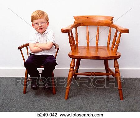 Boy and little and large chairs View Large Photo Image Stock Image - Boy and little and large chairs. Fotosearch