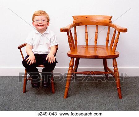 Boy and little and large chairs View Large Photo Image Stock Image - Boy and little and large chairs. Fotosearch