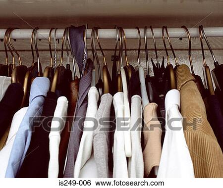 Stock Photograph - Clothes hanging in cupboard. Fotosearch