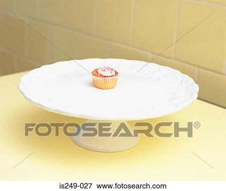 Cup-cake on a cake dish View Large Photo Image Stock Photo - Cup-cake on a cake dish. Fotosearch