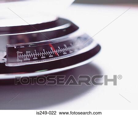 Stock Image - Kitchen weighing appliance. Fotosearch