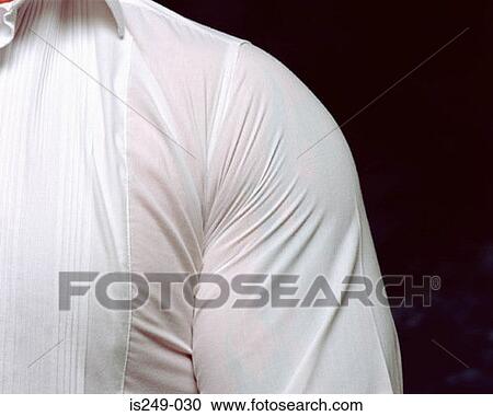 Stock Image - Man wearing very tight shirt. Fotosearch