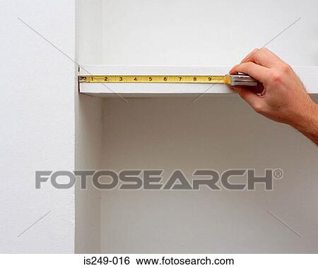 Stock Photograph - Measuring shelf length. Fotosearch