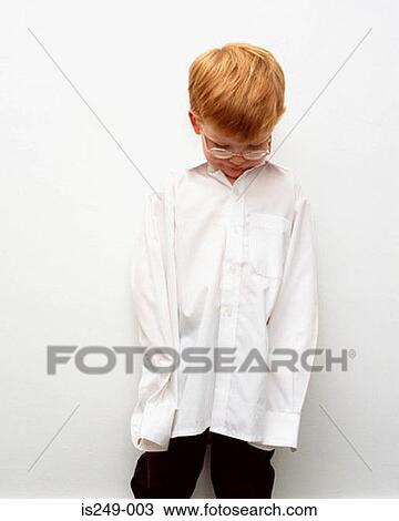 Stock Image - Young boy in oversized shirt. Fotosearch