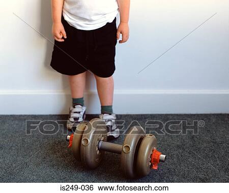 Stock Photograph - Young boy with dumb-bell. Fotosearch