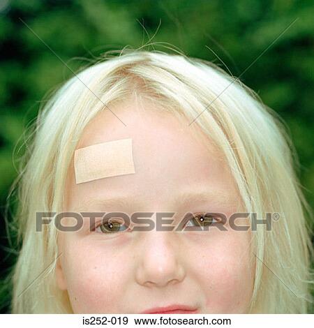 Girl with plaster on her forehead View Large Photo Image Stock Photo - Girl with plaster on her forehead. Fotosearch