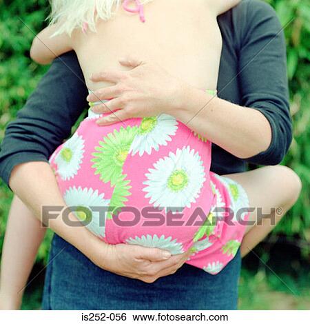 Woman hugging girl View Large Photo Image Stock Photograph - Woman hugging girl. Fotosearch