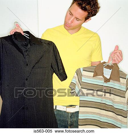 Stock Photography - Man choosing what to wear. Fotosearch