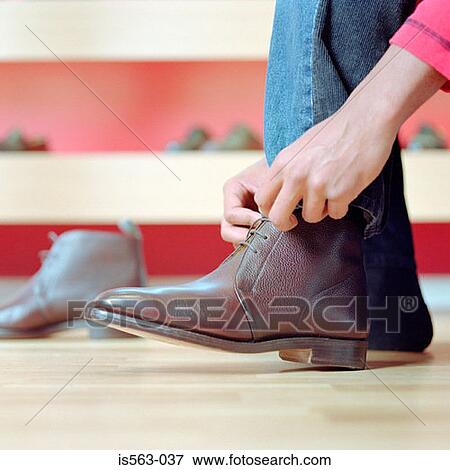 Man in shoe store View Large Photo Image Stock Photo - Man in shoe store. Fotosearch